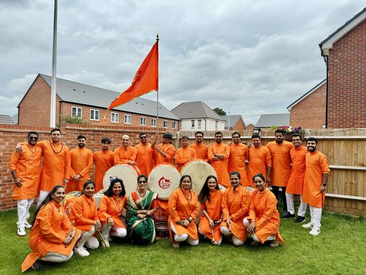 Pathak posing with the saffron flag and dhols