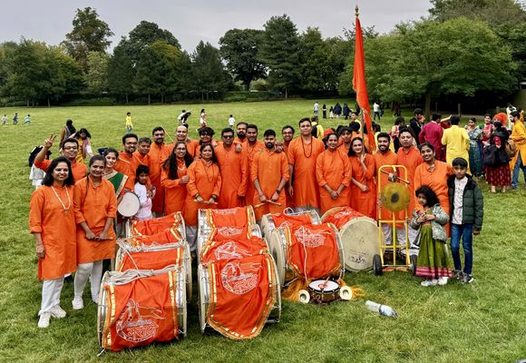 Pathak with dhols and flag at the Ganesh festival in the park